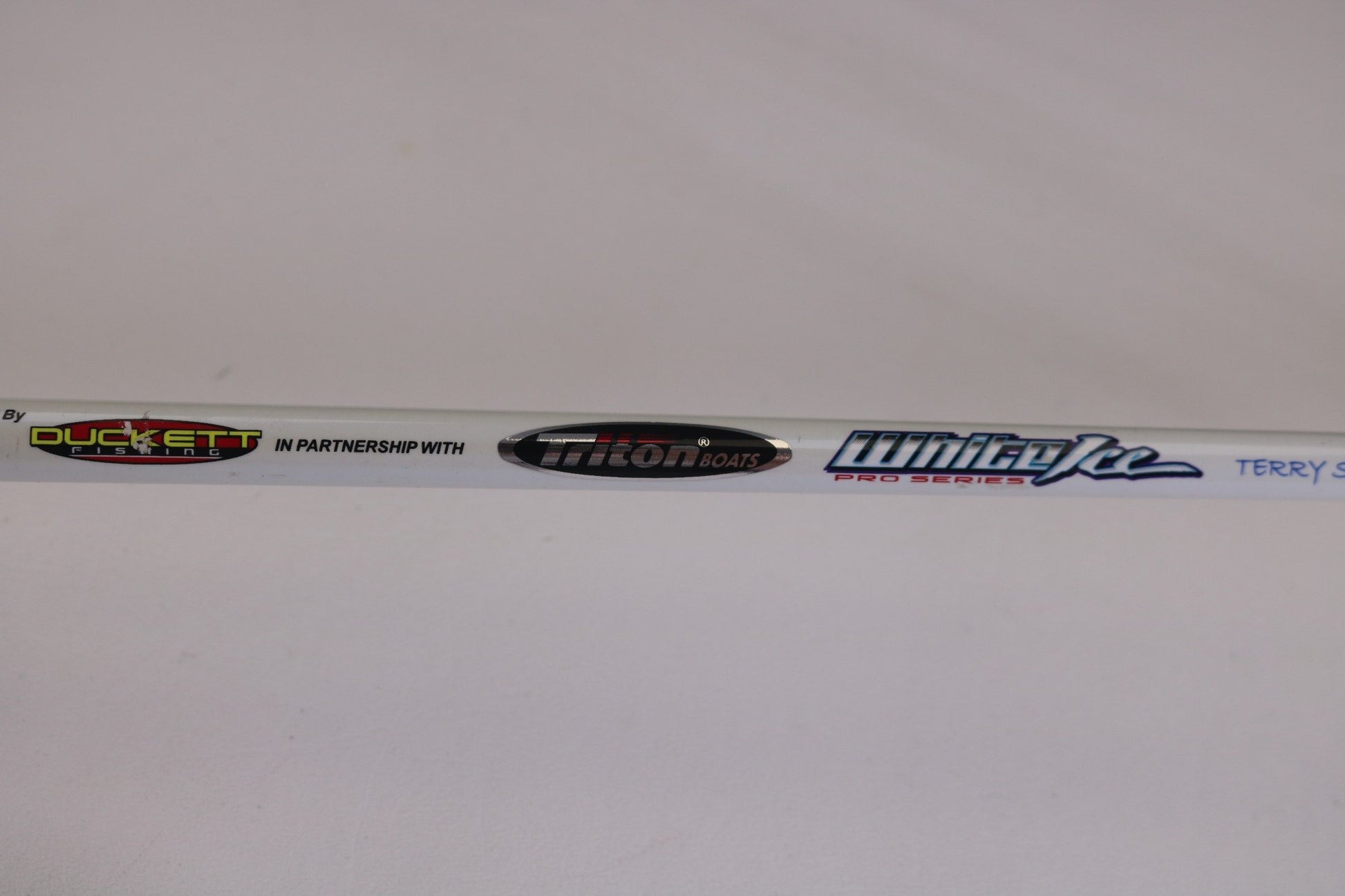 A close-up of a used Duckett White Ice TR-DFWI68MHS 6'8" Medium Heavy spinning rod in good condition. Great for those trading in used gear or earning store credit with our Rod and Reel Trade-In program.