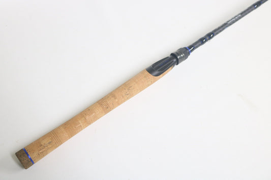The Dobyns Champion XP DC705SF Used Spinning Rod, in excellent condition, features a cork grip and black reel seat, and is shown against a plain white background.