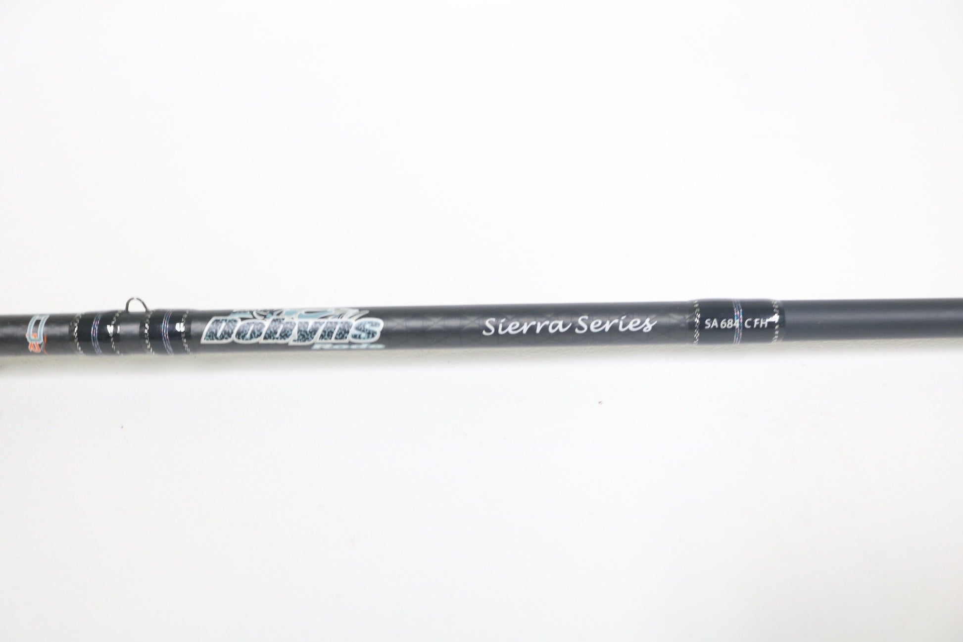 A close-up of a Dobyns Sierra SA684C Used Casting Rod in excellent condition, showing the brand name and details on the blank against a plain white background.