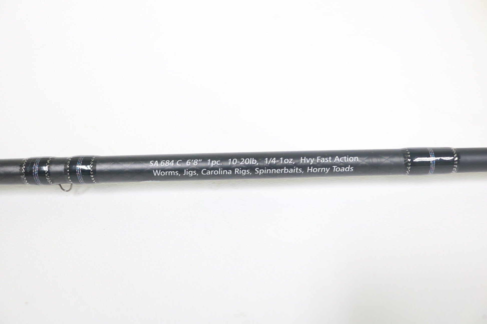 A close-up of the Dobyns Sierra SA684C Used Casting Rod in excellent condition, black with white specs: 6'8", 10-20lb, 1/4-1oz, heavy fast action—ideal for worms, jigs, Carolina rigs, spinnerbaits, and horny toads.