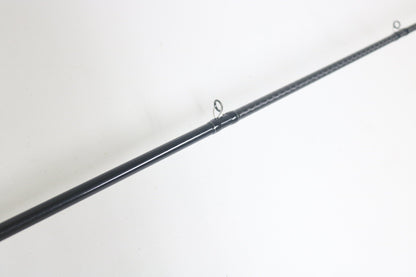 A close-up of a Shimano Expride A EX172MHGA Used Casting Rod in excellent condition, lying diagonally on a white surface, with two line guides visible.