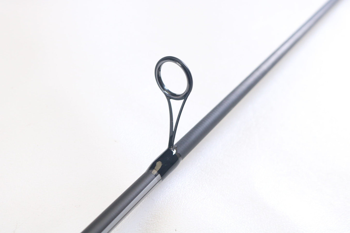 A close-up of the Abu Garcia Winch WINCHS72-4 7'2" Medium Light Used Spinning Rod’s line guide against a white background—ideal for highlighting this excellent condition rod in our Trade-In program.