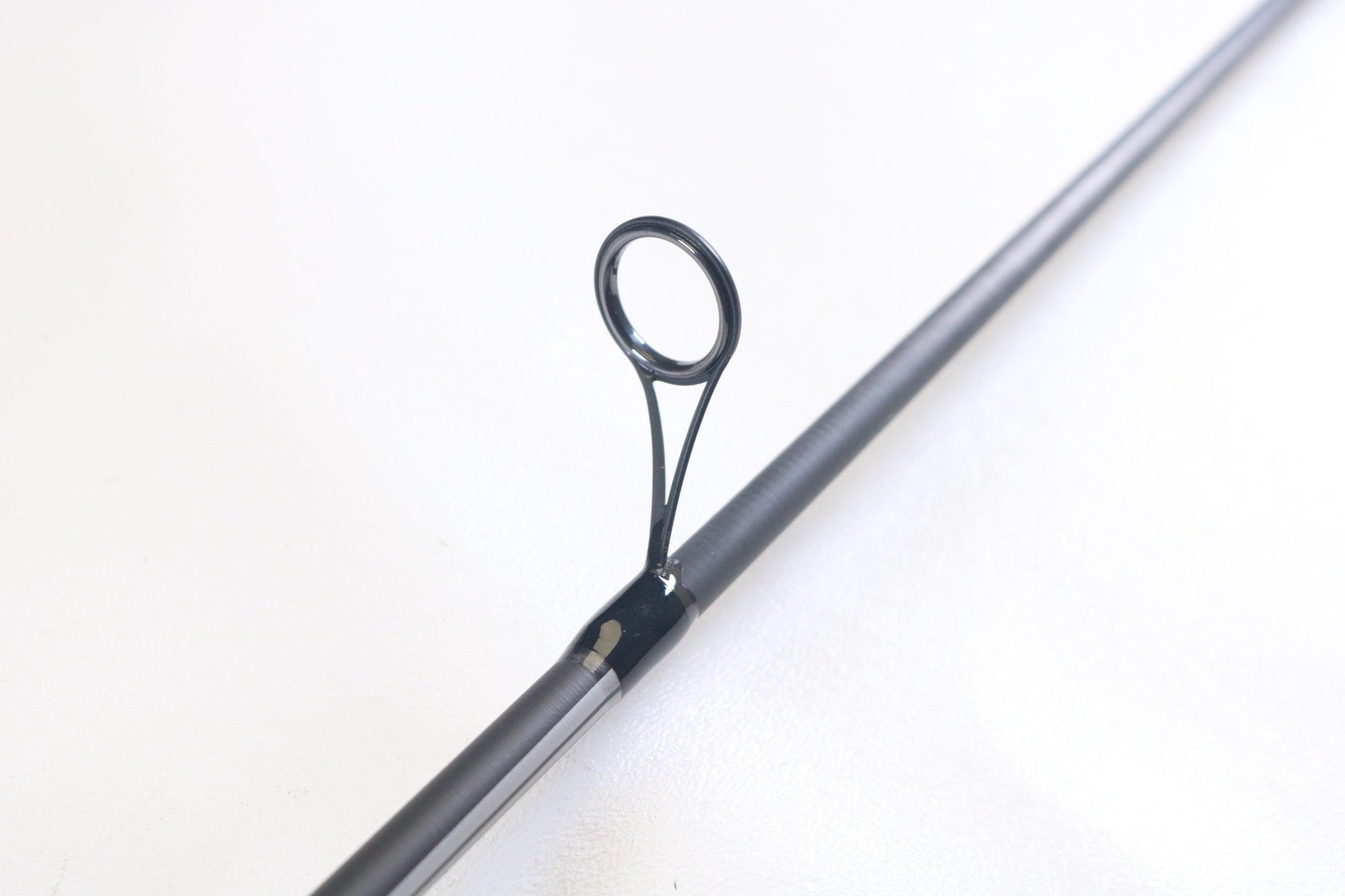 A close-up of the Abu Garcia Winch WINCHS72-4 7'2" Medium Light Used Spinning Rod’s line guide against a white background—ideal for highlighting this excellent condition rod in our Trade-In program.
