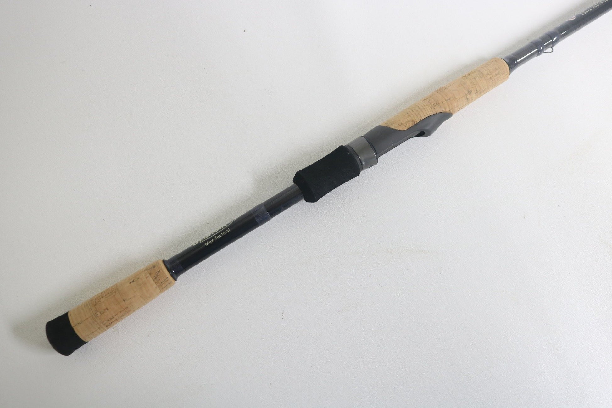 The St. Croix Victory VTS73MXF Used Spinning Rod, in excellent condition, features cork handles, a black reel seat, and a graphite body. It is shown lying diagonally on a white background.