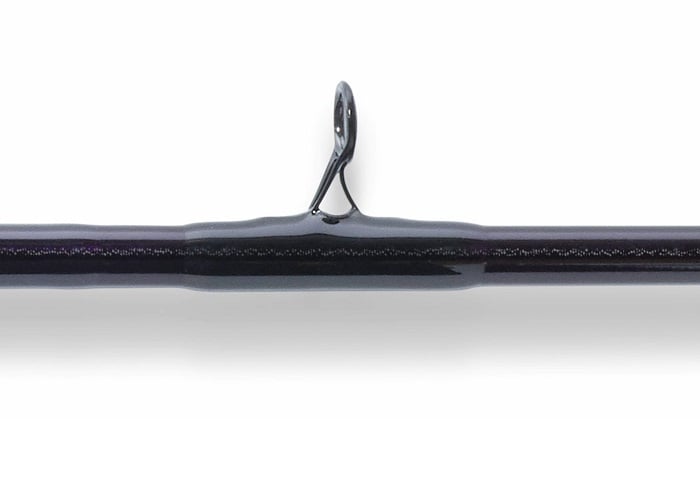 Close-up of a rod guide on the St. Croix Mojo Jig 5'8" Heavy Conventional Rod (MJJC58HMF), showing the metal loop on this dark saltwater jigging rod, ideal for vertical jigging, against a white background.