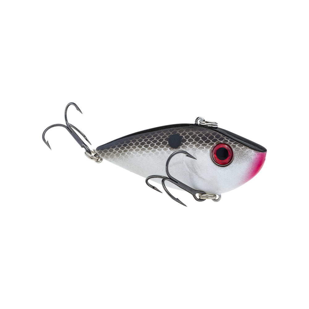 The Strike King Red Eye Shad by Strike King is a fish-shaped lipless crankbait with a gray and white body, black scale top, red gill spot, vivid red eyes, and premium hooks underneath and at the tail—ideal for mimicking live prey.