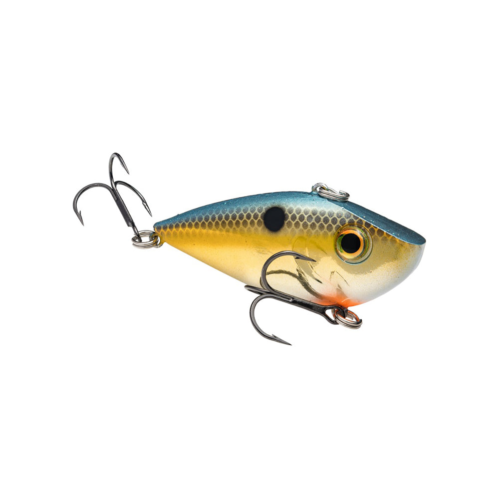 The Strike King Red Eye Shad by Strike King is a colorful, lipless crankbait fishing lure shaped like a small fish, with a blue back, yellow sides, white belly, premium hooks, and a realistic fish eye.