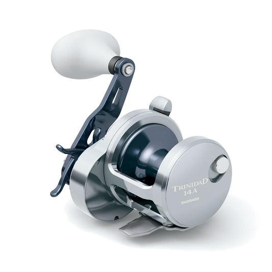 The Shimano Trinidad 14A Conventional Reel by Shimano is silver with a white handle, displayed on a plain white background. Built for saltwater use, it features detailed mechanics and High Efficiency Gearing for top performance.