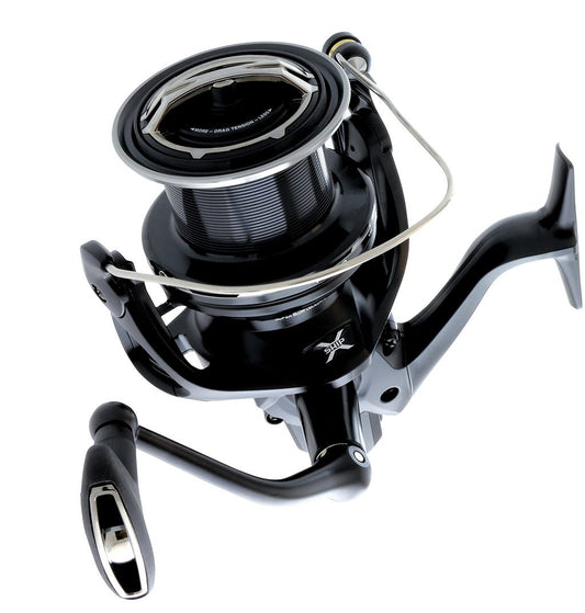 A close-up of the Shimano Ultegra XTD Surf Reel ULT5500XTD features a sleek black design with a metal handle and spool, delivering long-casting performance against a white background.